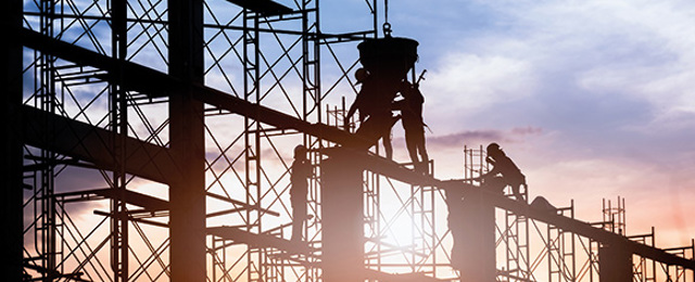 Construction workers casting concrete columns