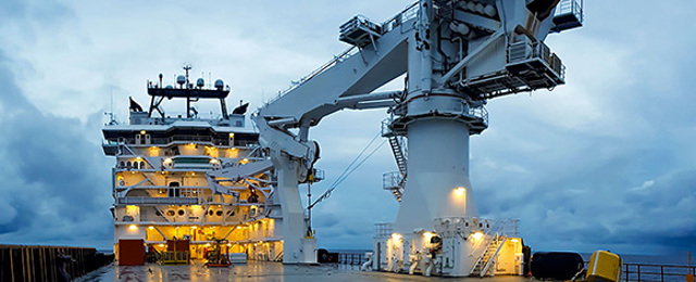 Deck of cargo ship with crane at sea